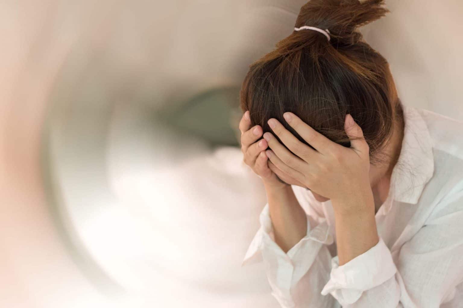 woman holding head with spinning graphic displaying a sense of disorientation